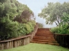 Newcastle_Pawleys Island_pile retaining wall with native grasses and native plants and wood steps