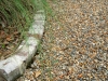 Livingston_soldier brick border in gravel driveway with native grass